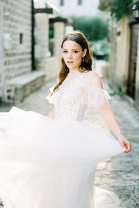 Portrait of young woman standing in water