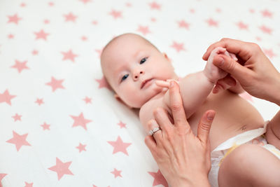 High angle view of cute baby girl lying on bed