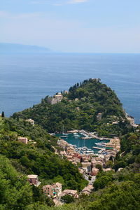 High angle view of townscape by sea against sky