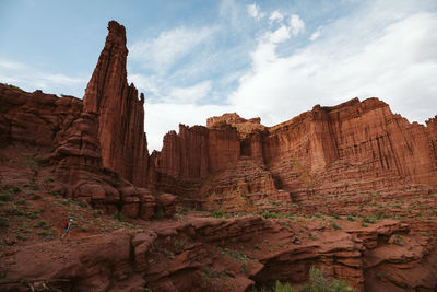 Hiker looks small under the titan, the largest of the fisher towers