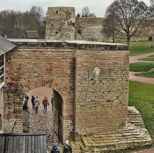 People on wall against building