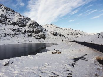 Scenic view of snow covered mountains against sky