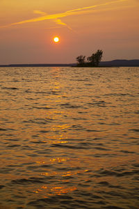 Scenic view of sea against orange sky