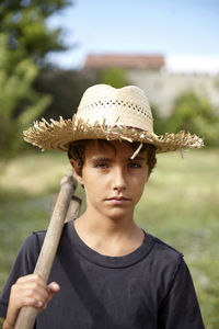 Portrait of young woman wearing hat standing outdoors