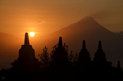 Silhouette temple against sky during sunset