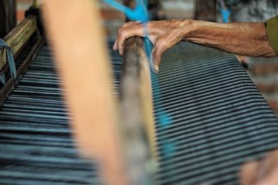 Close-up of hands worker weaving in textile factory