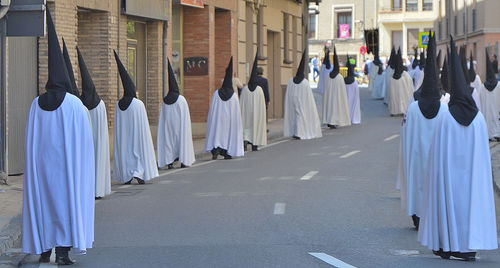 People on street amidst buildings in city