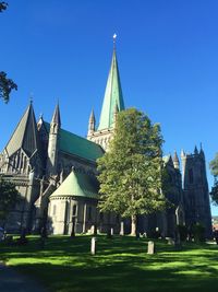 Low angle view of church against clear blue sky