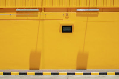 View of footpath with yellow building