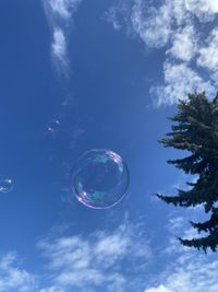 Low angle view of bubbles against sky