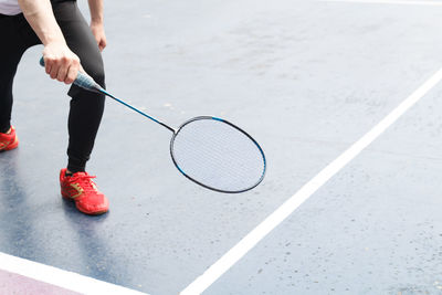 Low section of man playing badminton