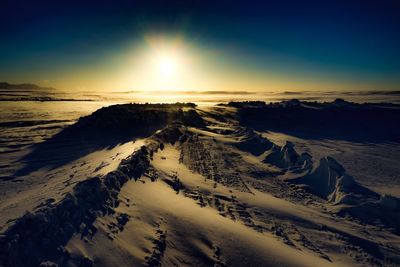 Scenic view of beach against sky during winter