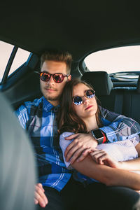 Young couple driving car