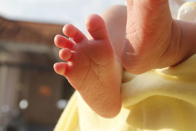 Low section of newborn lying on bed