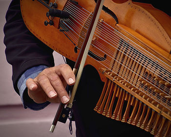 Midsection of man playing guitar