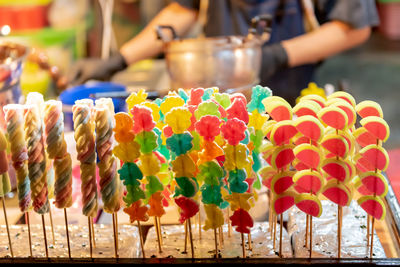 Multi colored candies for sale at market stall