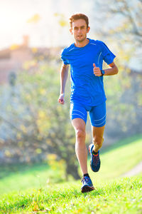 Full length of man running on grass