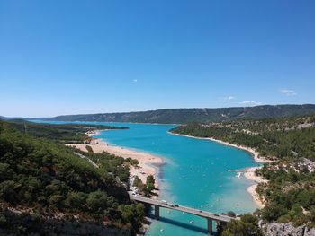 High angle view of sea against clear blue sky