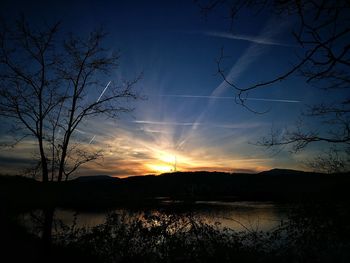 Scenic view of silhouette trees against sky at sunset