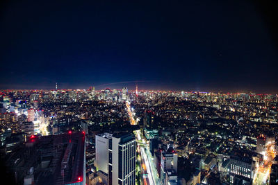 High angle view of city lit up at night