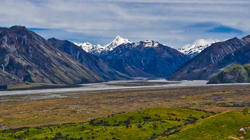 Scenic view of lake and mountains against sky