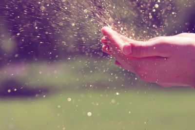 Close-up of splashing water on hands