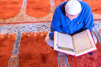 High angle view of man reading book