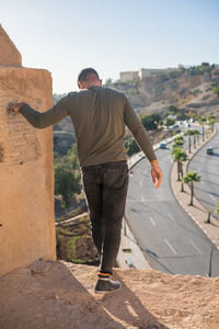 Unrecognizable man standing on the historical wall surrounding the old medina of fes