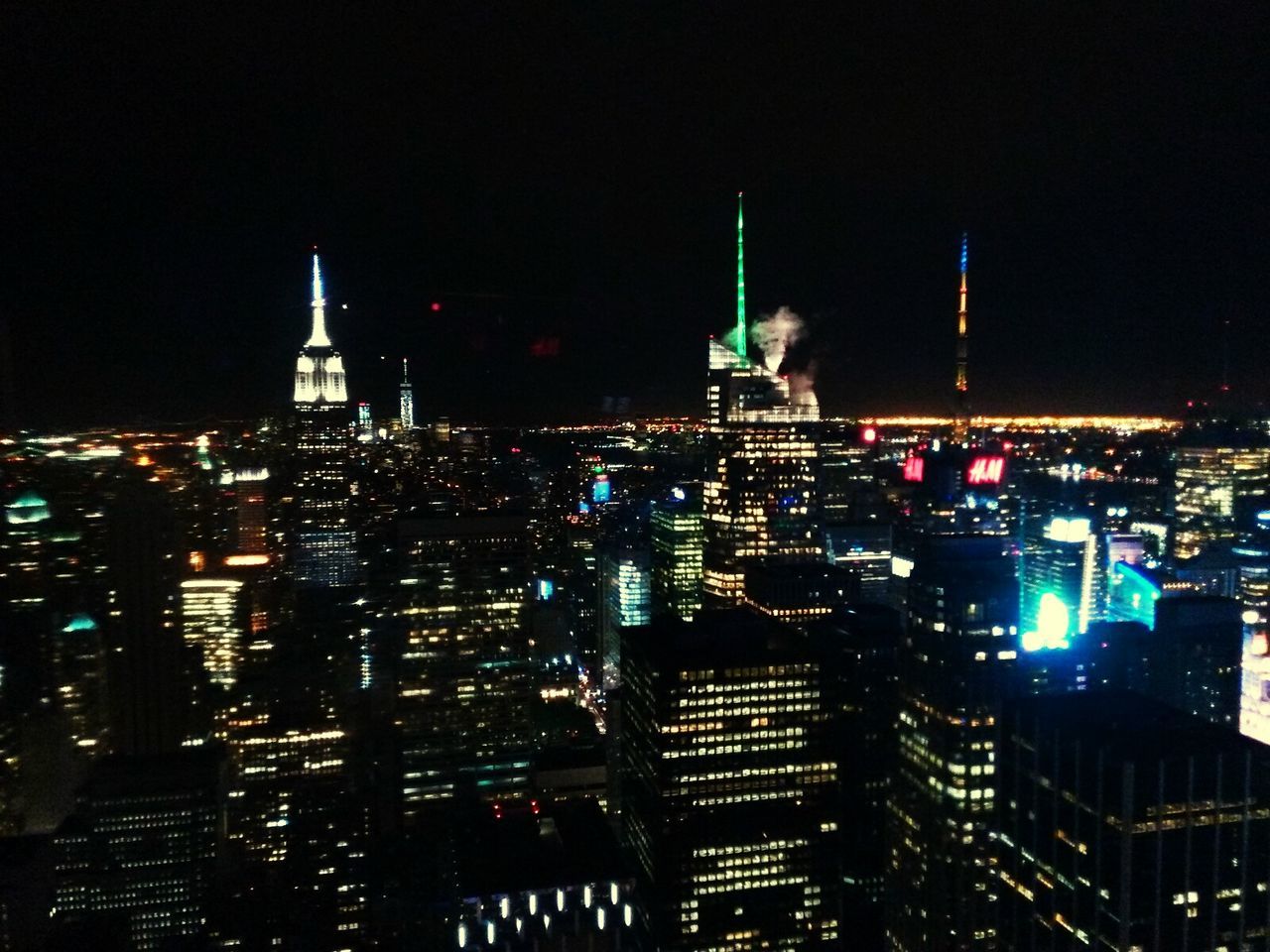 VIEW OF ILLUMINATED CITYSCAPE AT NIGHT