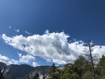 Low angle view of mountain against blue sky