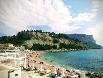 Panoramic view of bay against cloudy sky