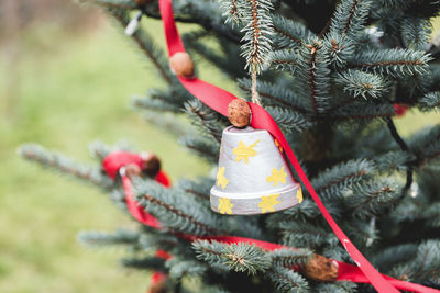 Handmade decoration made of small flower pot on a christmas tree outdoor. diy creative ideas