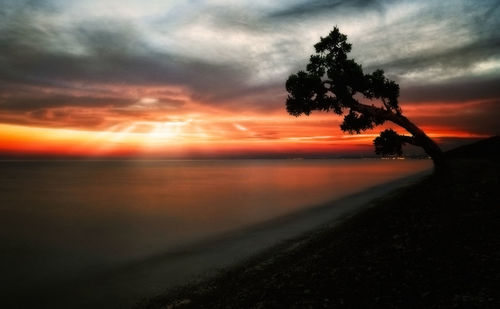 Scenic view of sea against orange sky