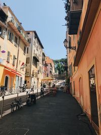 Street amidst buildings against sky in city