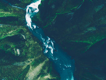 Scenic view of river amidst mountains