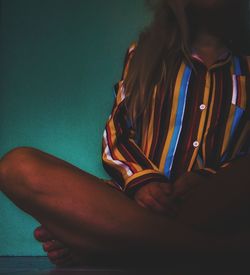 Low section of woman sitting on floor