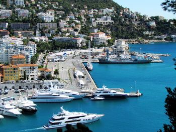 Boats moored at harbor in city