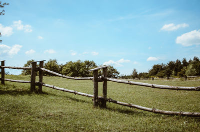 Fence on field against sky