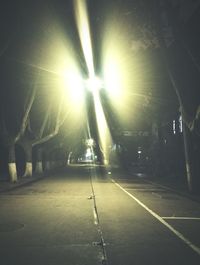 Illuminated tunnel at night