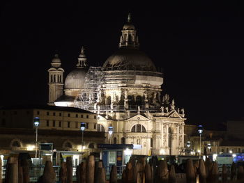 Illuminated building against sky at night in city