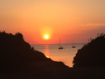 Scenic view of sea against orange sky