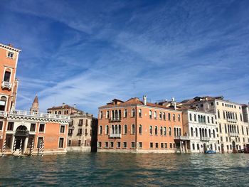 Canal passing through buildings in city