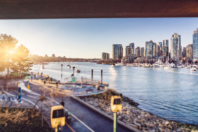 Panoramic view of sea and buildings against sky during sunset