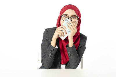 Portrait of mid adult woman against white background