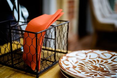 Close-up of orange slice in basket on table