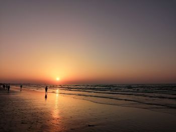 Scenic view of sea against clear sky during sunset