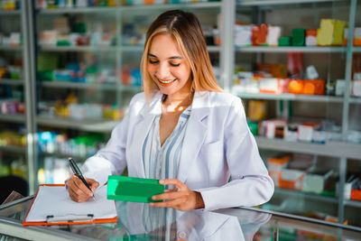 Portrait of young businesswoman working at supermarket