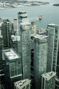 High angle view of buildings by sea in city