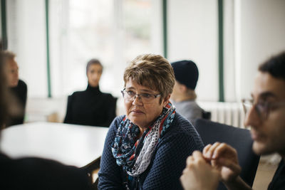 Mature woman listening during informal meeting