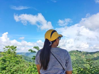 Rear view of man standing against sky